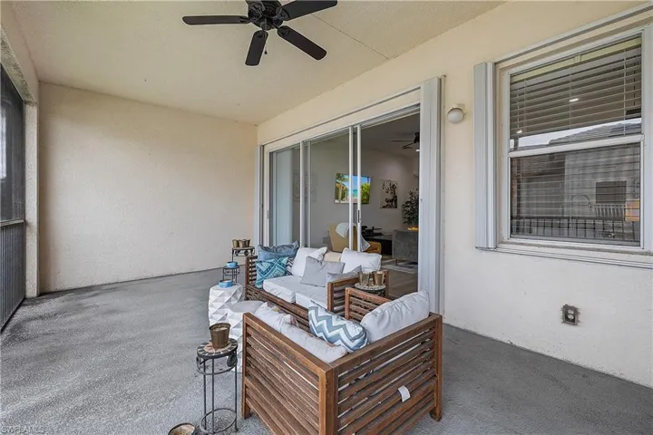View of screened lanai with an outdoor living space and ceiling fan