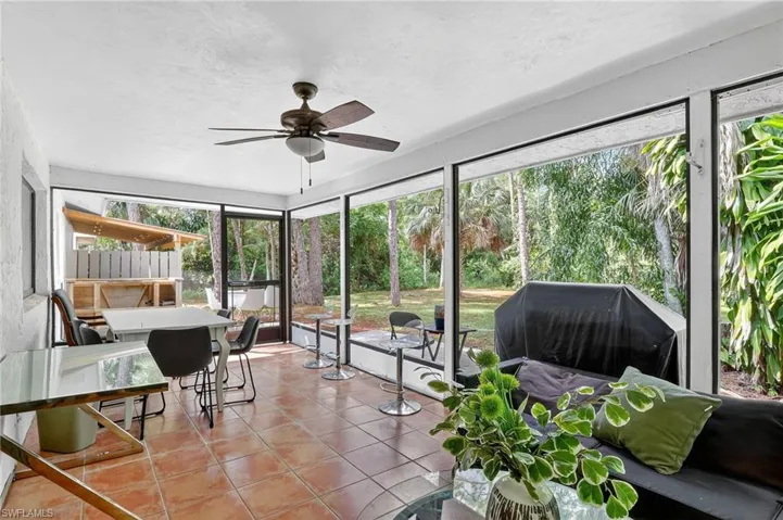 Sunroom with a ceiling fan and outdoor dining area