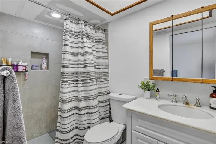 Bathroom featuring vanity and a tile shower