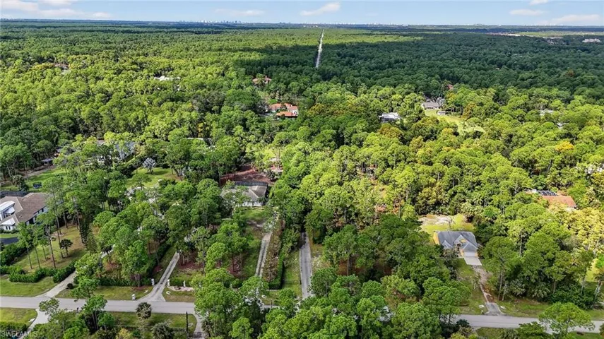 Aerial view of property's location featuring a forest