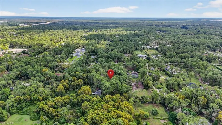 Aerial view of property's location with a forest