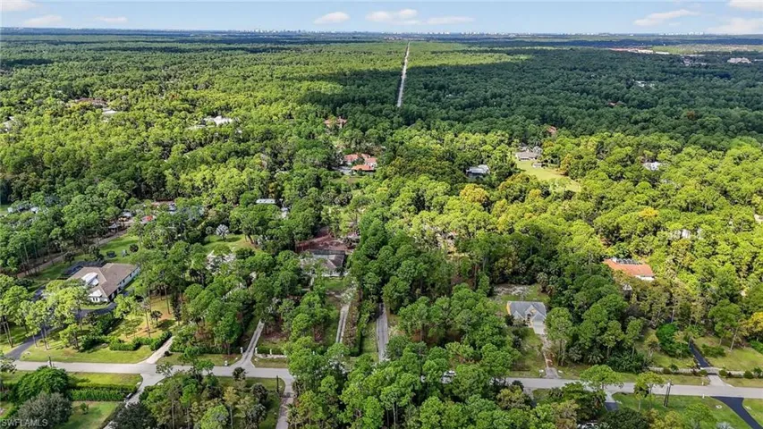 Aerial view of property's location with a forest
