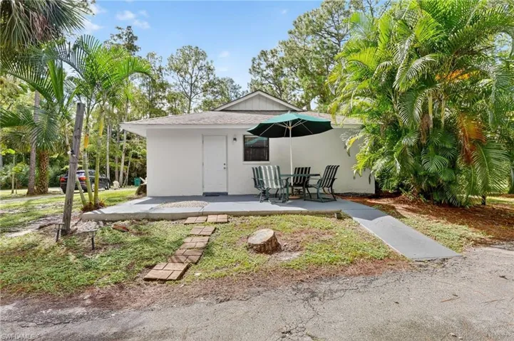 Back of house featuring stucco siding