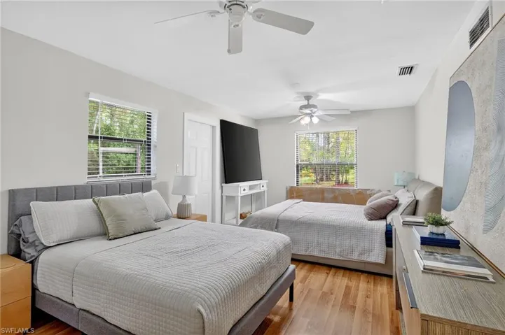 Bedroom with wood finished floors and a ceiling fan