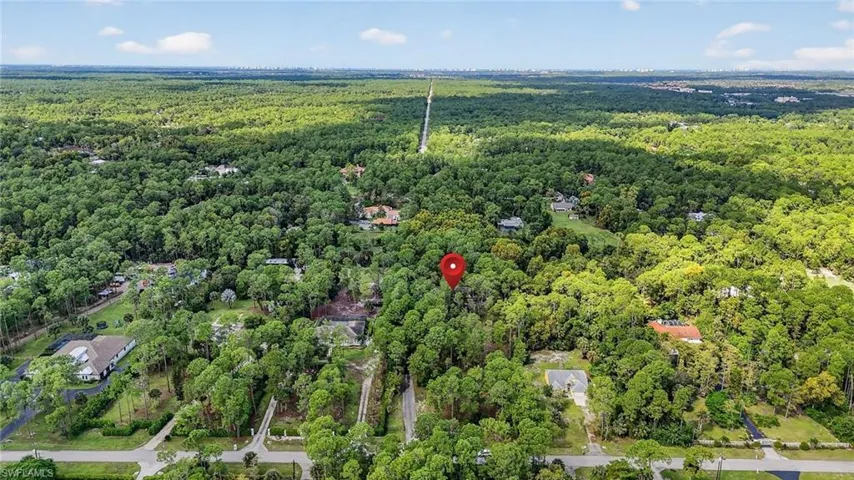 Aerial overview of property's location featuring a heavily wooded area
