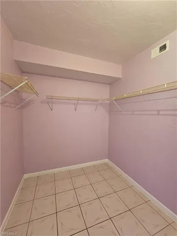 Walk in closet featuring light tile patterned floors