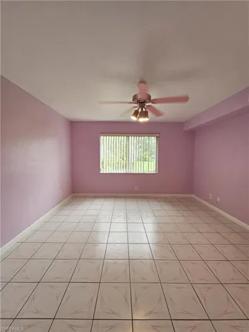 Spare room featuring ceiling fan and light tile patterned floors