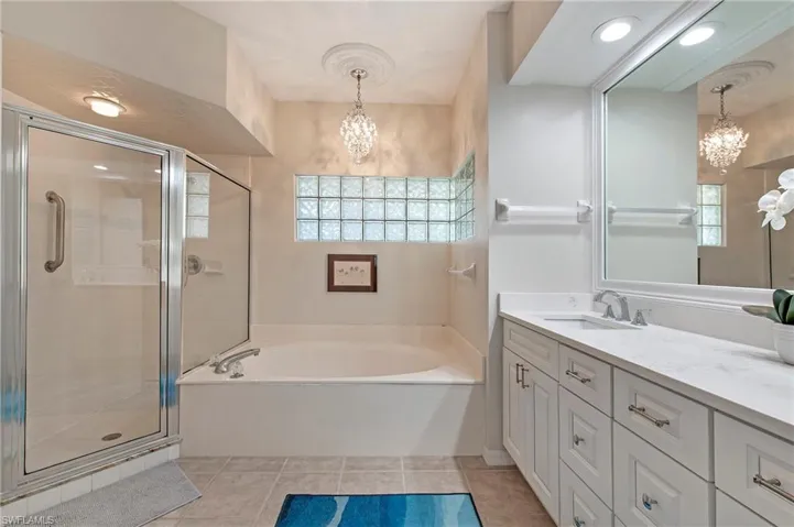En suite primary bath with dual sinks, soaking tub and walk in shower.