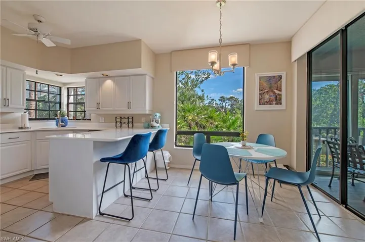 Kitchen overlooks preserve and lake view with access to the lanai.