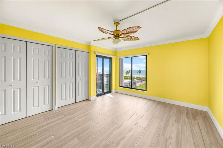 Primary bedroom, crown molding, light wood-style flooring, and ceiling fan, Gulf front