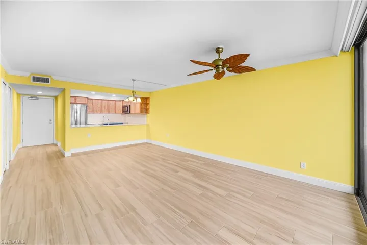 Living room, dining area, tile floor and ceiling fan.