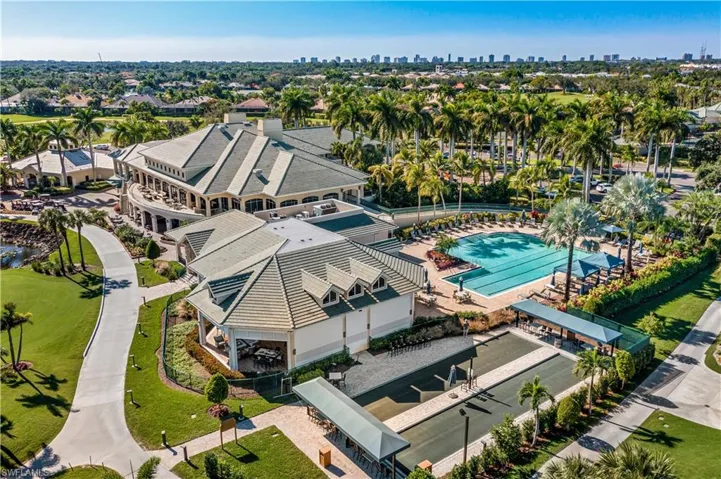Aerial view of salt water pool offering cabanas and fire pits with seating