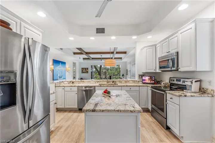 Kitchen offers open views to living area and lanai