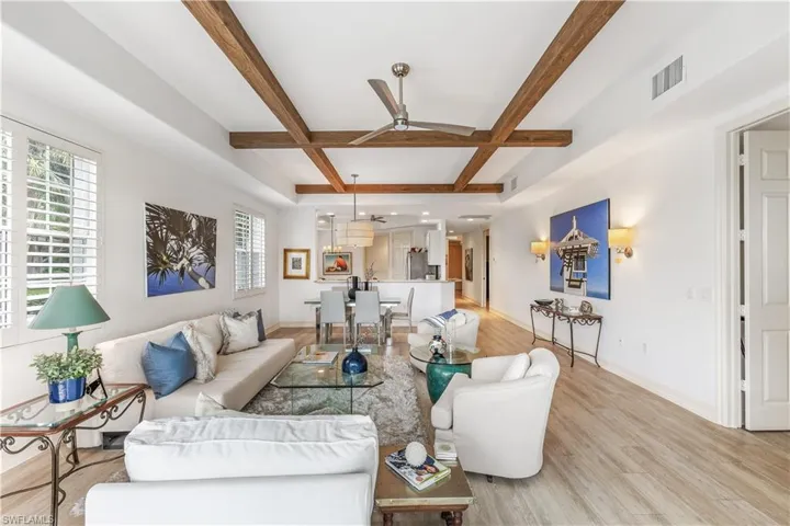 Beautiful living area with wood ceiling beams and commercial luxury vinyl throughout