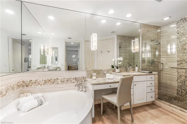 Primary bath with soaking tub, frameless shower door and 2 vanities