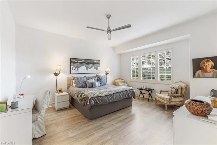 Primary bedroom with king size bed with private views to lush landscaping and golf course
