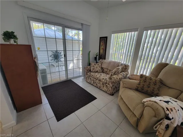 Living room with a wealth of natural light and light tile patterned floors