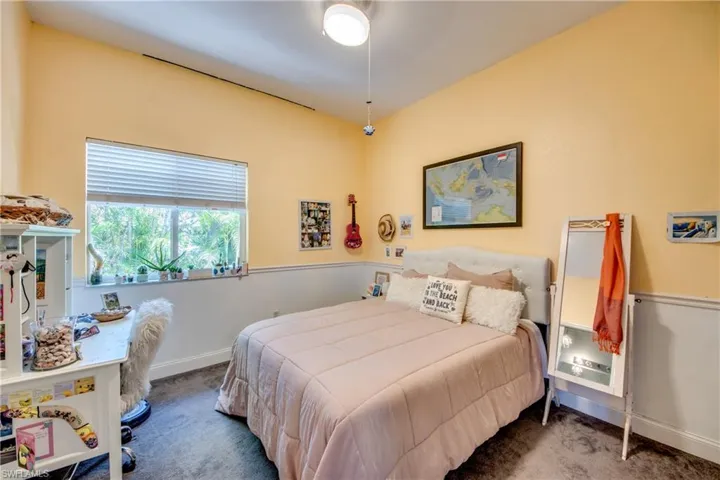Bedroom 3. All bedrooms have a ceiling fan, ensuite bathroom, and carpet.