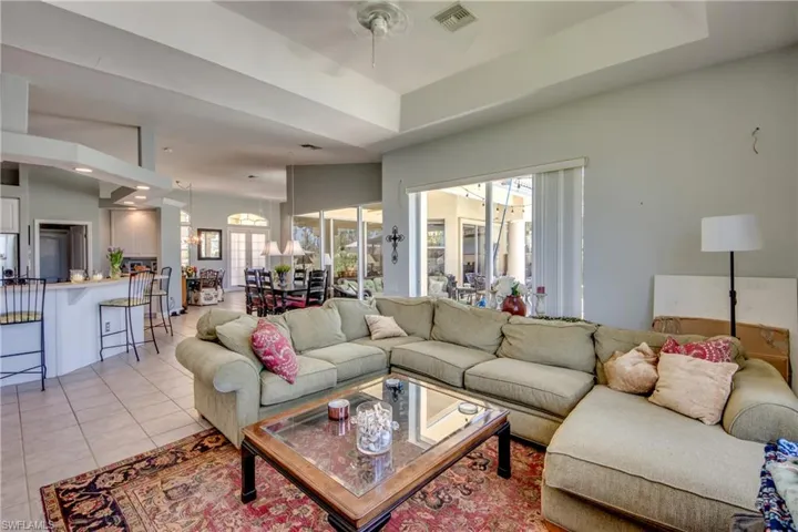 Family room view from back corner shows open concept as you can see the front doors with arched window above.