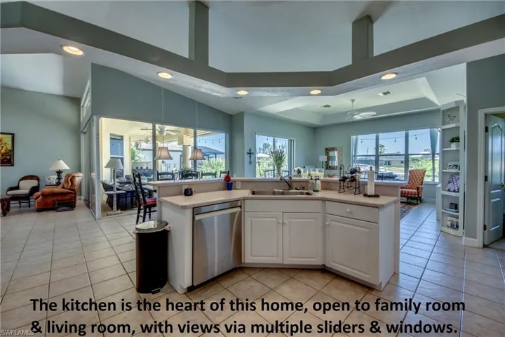 Kitchen island has a breakfast bar and overlooks the breakfast nook and family room. Living room is to the left. High ceilings throughout the home.
