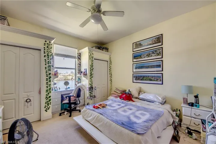 Bedroom 2 in the rear of the home has the perfect place for a desk with a great water view between the dual closets.