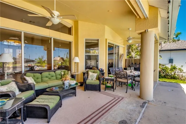 This view of the under truss lanai reveals sliders in the living room and the stackable sliders to the right which access the primary bedroom.
