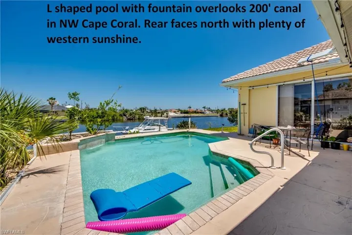 Inviting swimming pool in sunny SW Florida overlooks wide canal. Access to pool and lanai through several sliding doors.