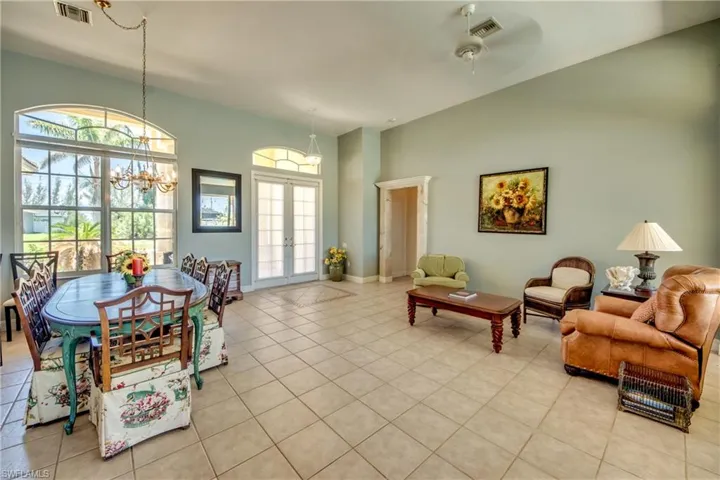 Formal dining room and formal living room are just inside the French doors at the front of the home. The primary bedroom is through the doorway to the right of the front doors.