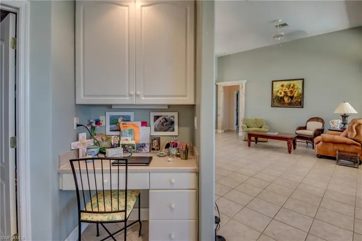 Kitchen desk with cabinets. Laundry room is to the left.