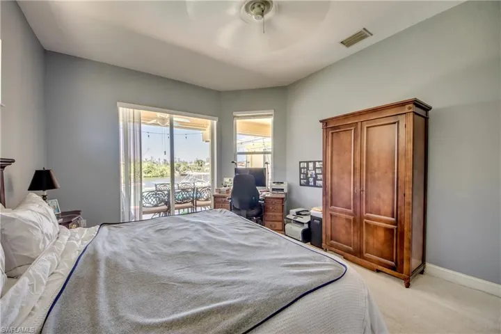 Primary bedroom has great view of canal and room for a desk with a view.