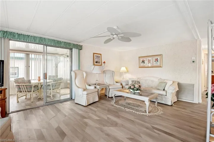 Living room with ceiling fan and wood finished floors