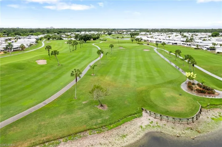 Aerial perspective of suburban area featuring a local golf course