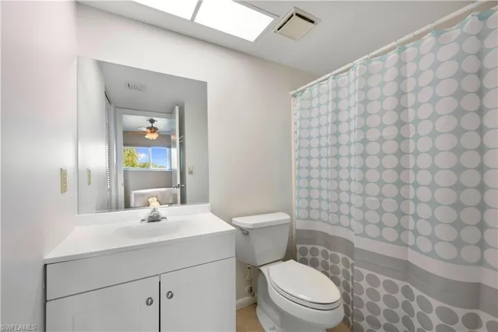 Bathroom with vanity and curtained shower