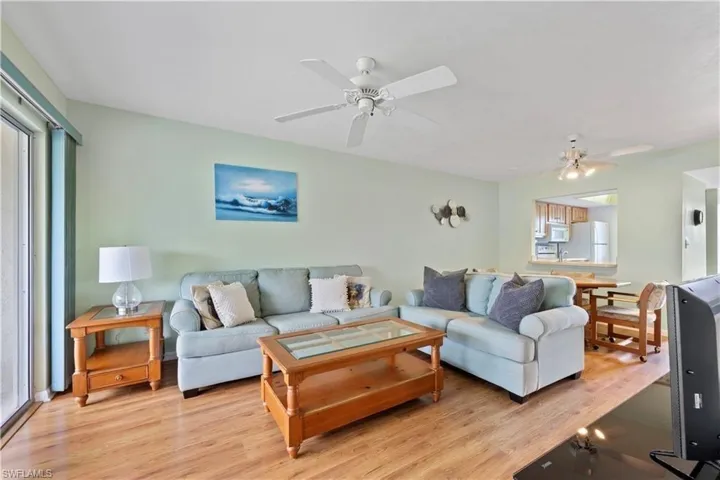 Living room with a ceiling fan and light wood-style flooring