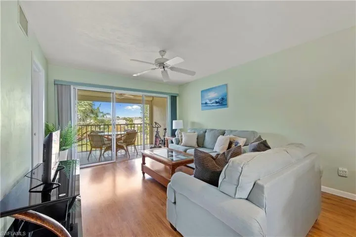 Living area featuring a ceiling fan and wood finished floors