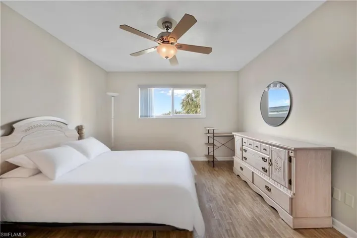 Bedroom with light wood finished floors and ceiling fan