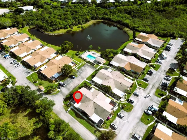 Aerial view of property's location with a large body of water and nearby suburban area