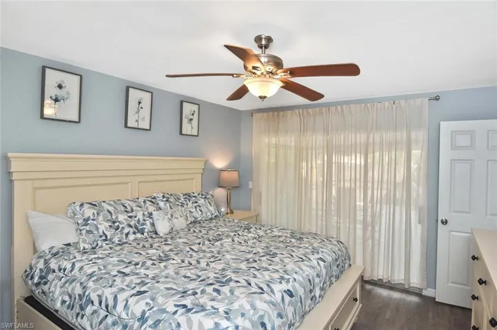 Bedroom featuring dark wood finished floors and a ceiling fan