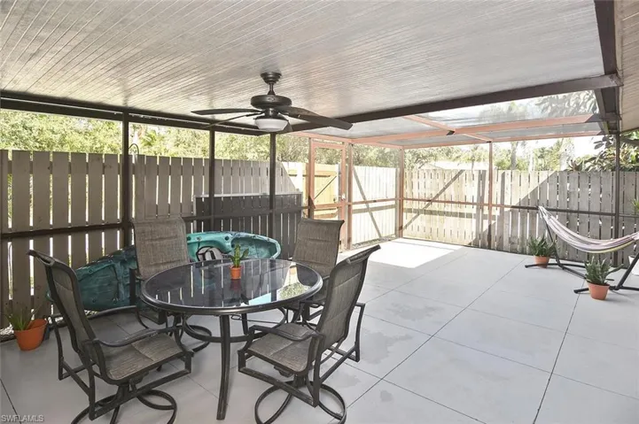 Sunroom / solarium with ceiling fan and outdoor dining area