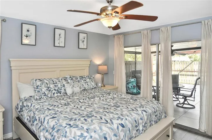 Bedroom with access to exterior and ceiling fan