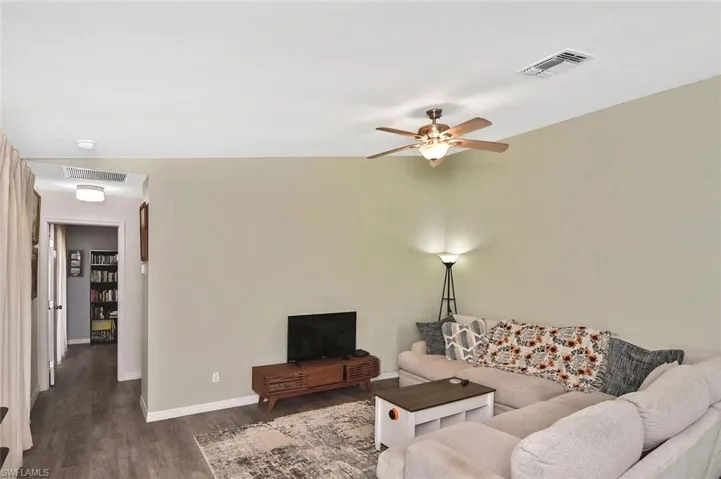 Living room featuring wood finished floors and ceiling fan