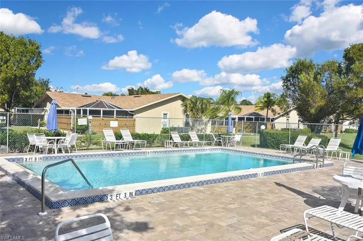Community pool featuring a patio