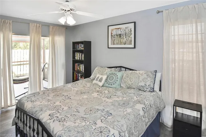 Bedroom featuring a ceiling fan and dark wood finished floors