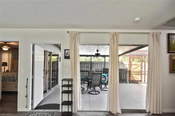 Doorway with a ceiling fan and a sunroom