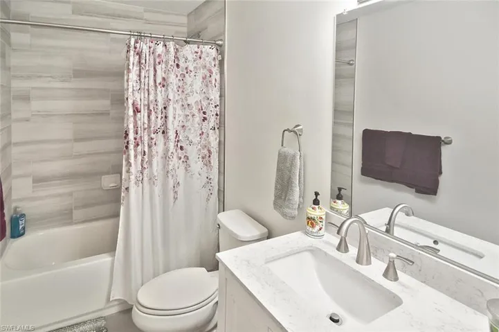 Bathroom with vanity and shower / tub combo with curtain