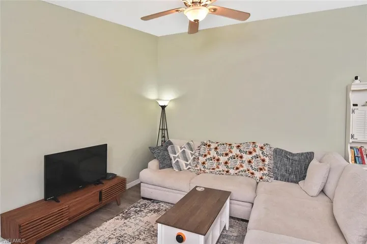 Living area with wood finished floors and ceiling fan
