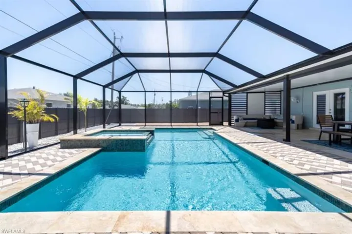 View of swimming pool featuring a patio and a lanai