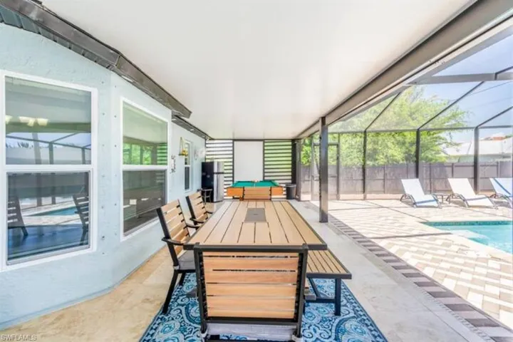 View of patio / terrace featuring glass enclosure and a fenced in pool