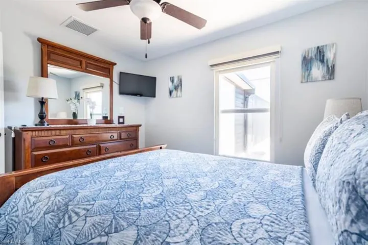 Bedroom with multiple windows and ceiling fan