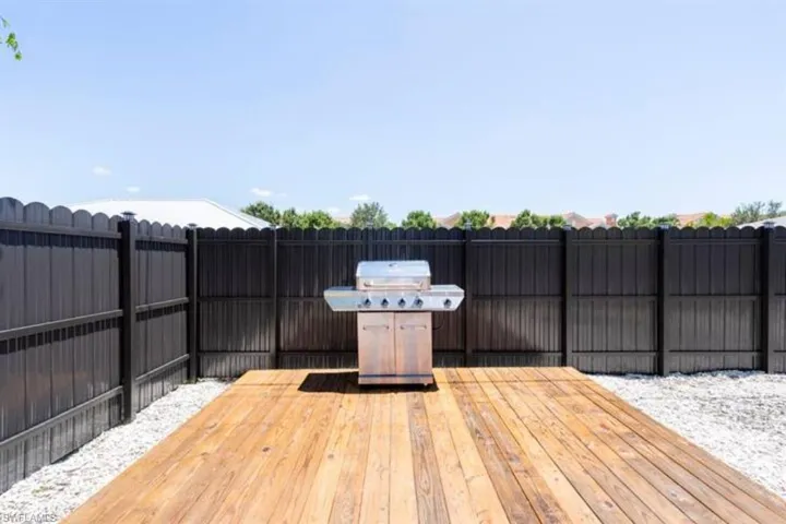 Wooden terrace featuring grilling area